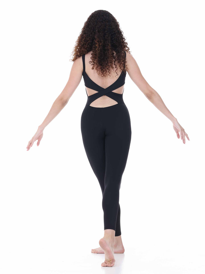 Vue arrière d’une bailarina en unitard negro, dos croisé ouvert – tenue technique de danza contemporánea.