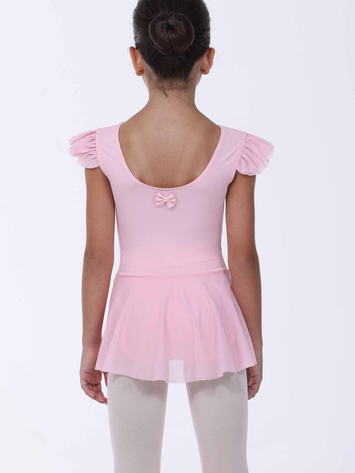 Vue di dos d’une abito di danse rosa clair da bambina – nœud décoratif e gonna fluido.