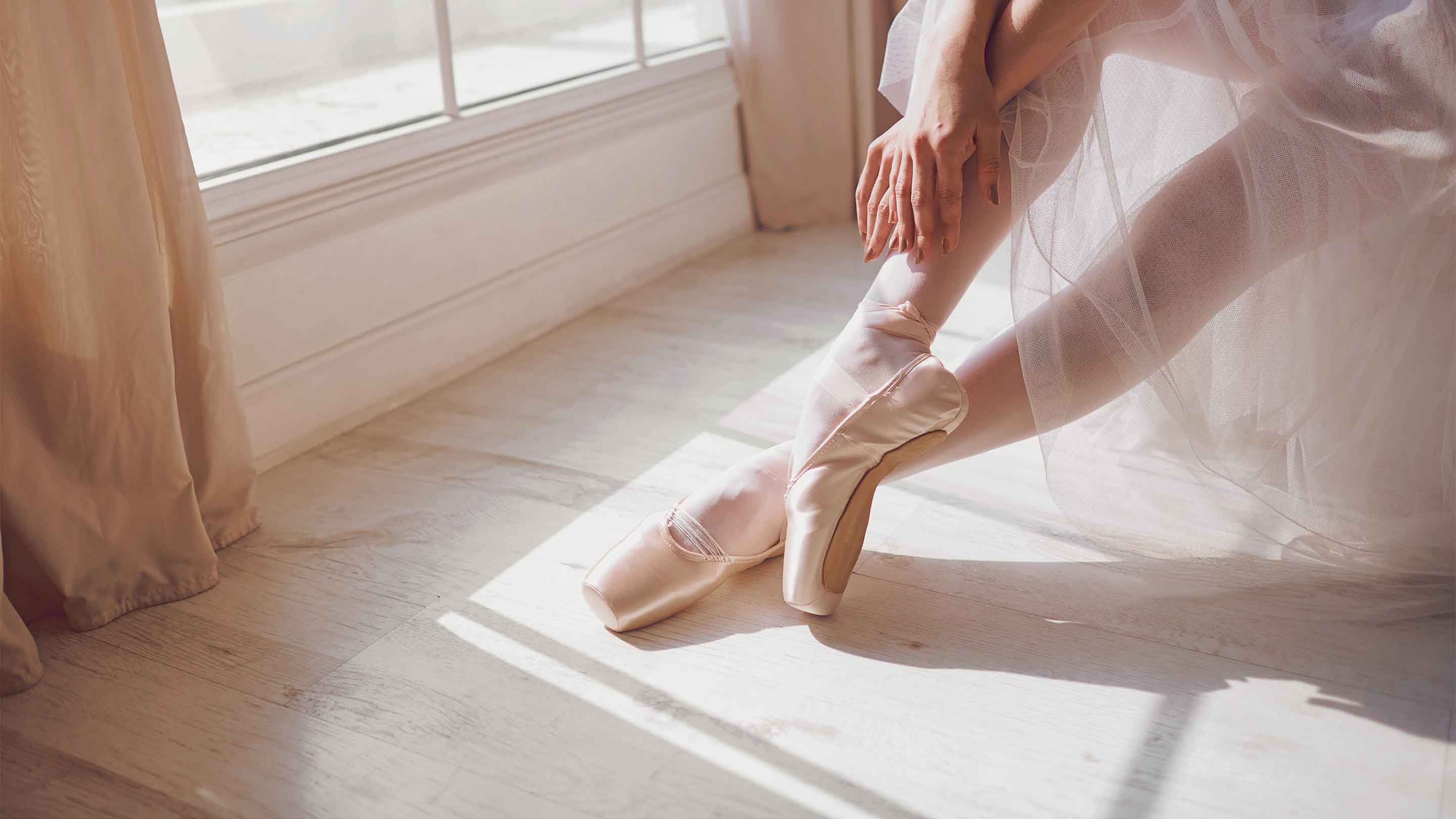 Ballet dancer in pointe shoes wearing a tulle skirt, representing Sway’s women’s ballet skirts collection.
